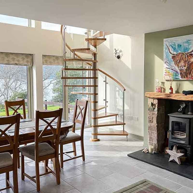 living area with dining tabel and spiral staircase