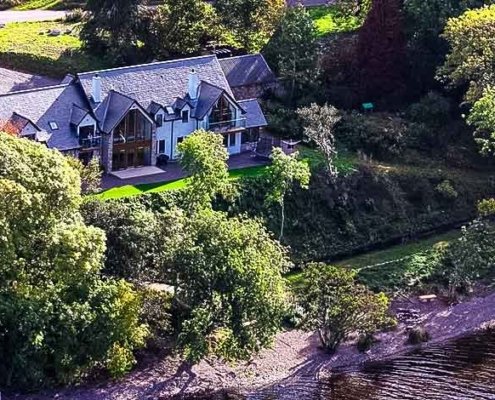 aerial view of house beside a lake