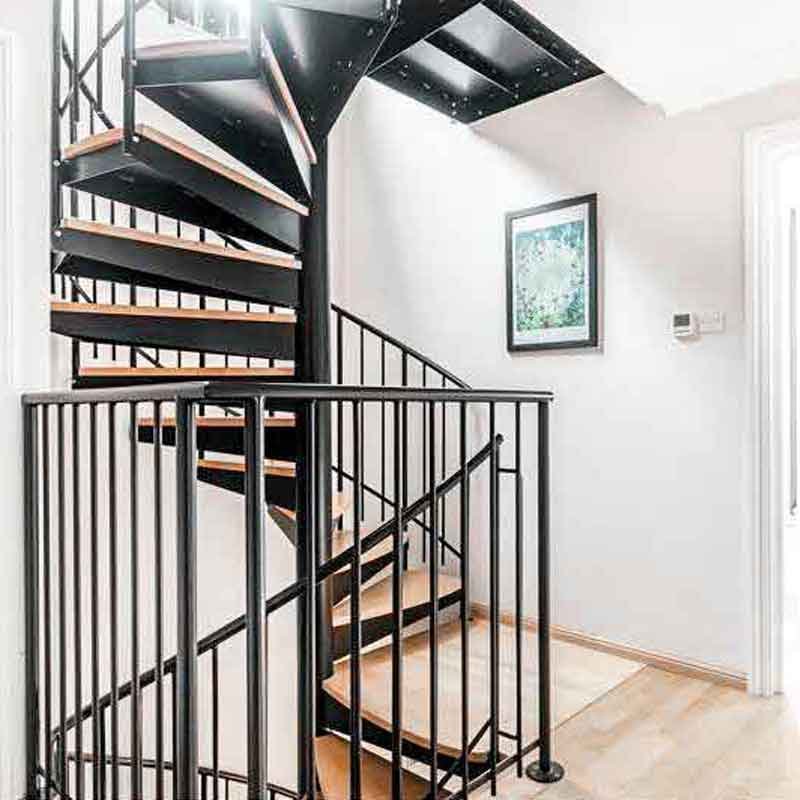 spiral-stair-with-black-spindles-on-an-oxford-home-with-white-walls