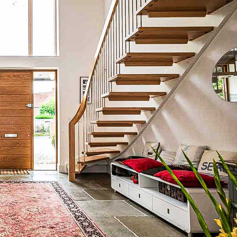 Floating-open-staircase-running-down-a-wall-in-a-large-walkway