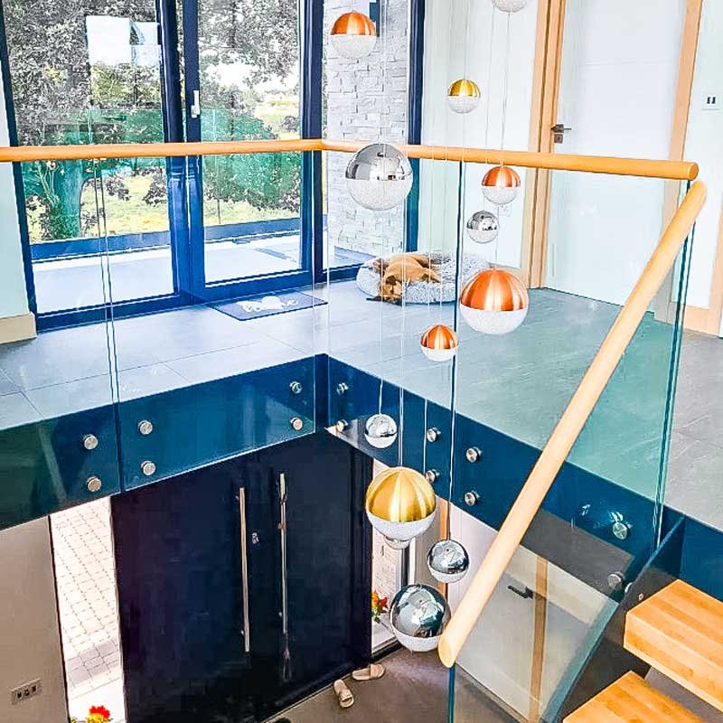 Circular-lights-hanging-down-an-open-stairwell
