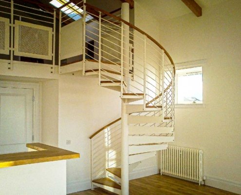 Horizontal-steel-bars-wrappng-around-a-white-steel-spiral-stair