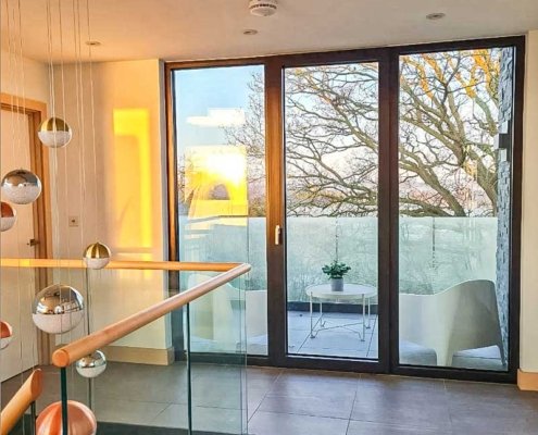 Landing-area-in-house-around-glass-balustrade