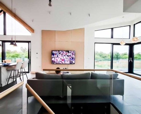 Large-upstairs-living-room-with-sofa-and-TV-on-wall