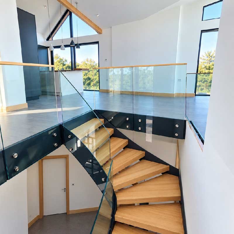Modern-steel-and-glass-staircase-leading-up-into-an-open-living-space