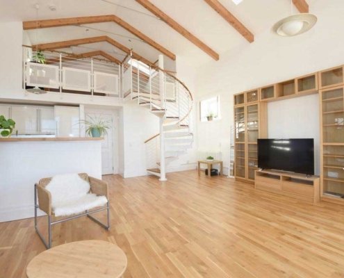 Oak-and-steel-spiral-stair-on-an-oak-floor-in-a-dwelling