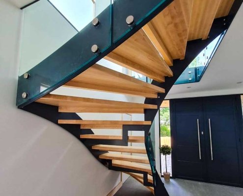 Underside-of-birch-tread-staircase-from-a-grey-hallway