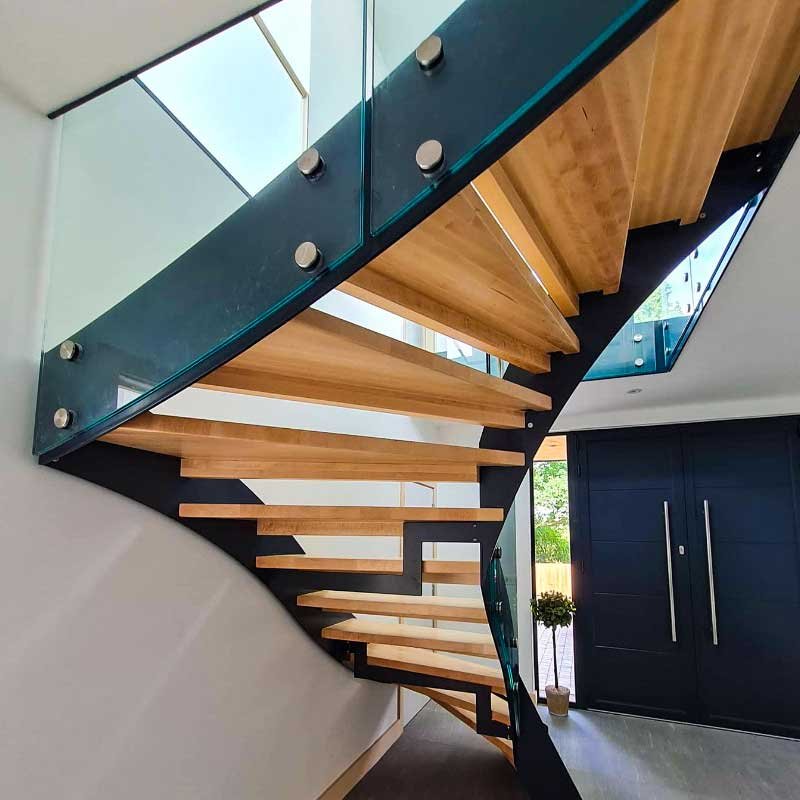 Underside-of-modern-steel-and-glass-staircase-in-a-house
