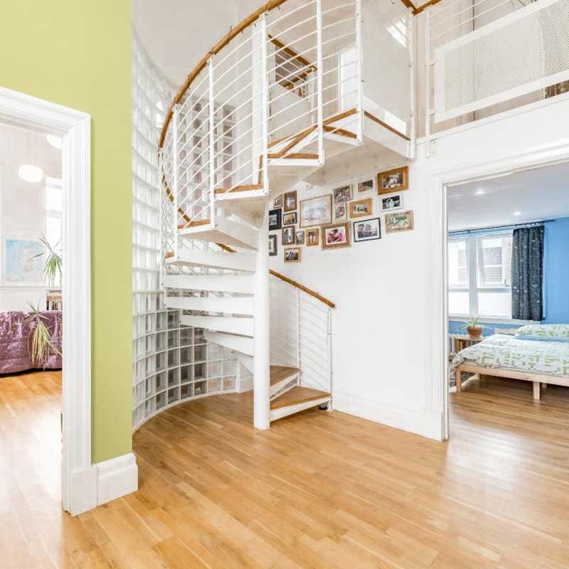 white-steel-spiral-leading-to-upper-level-in-penthouse