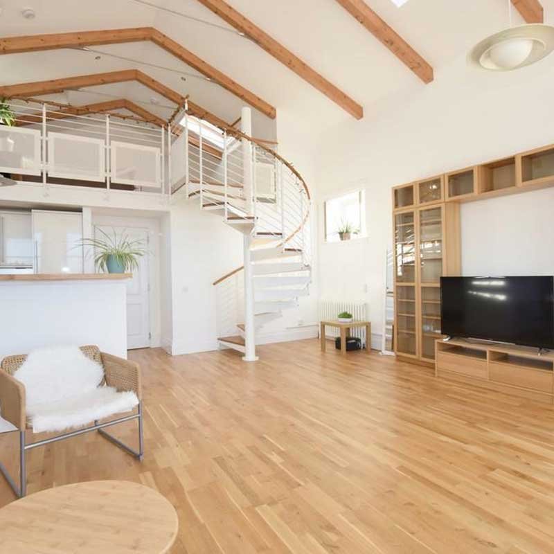 white-steel-spiral-stair-leading-to-a-mezzanine-deck